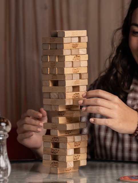 A carefully chosen move in a game of Jenga at DNA